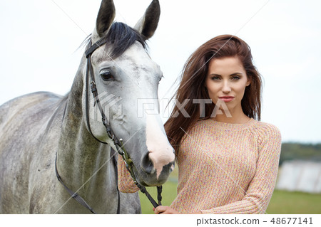 woman long hair kissing beautiful horse 48677141