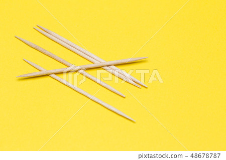 Toothpicks on a yellow isolated background Toothpicks on a yellow isolated background 48678787