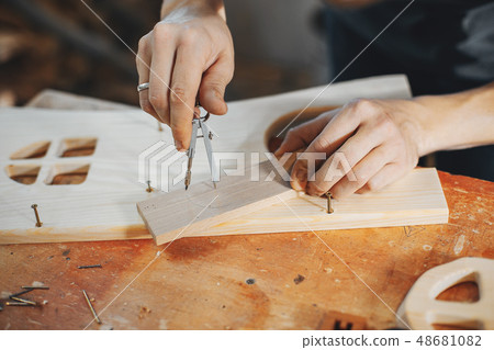 The carpenter works with a tree The carpenter works with a tree 48681082