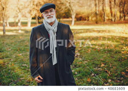 Elegant old man in a sunny autumn park  48681609