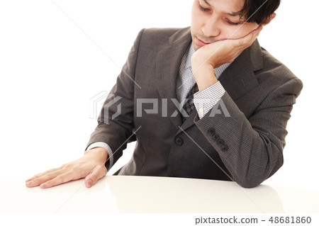 A tired businessman A tired businessman 48681860