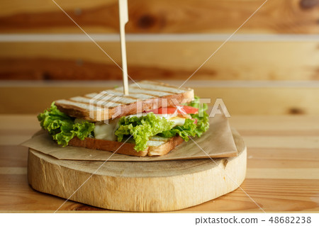 juicy sandwich with bacon, fresh vegetables, green juicy sandwich with bacon, fresh vegetables, green 48682238
