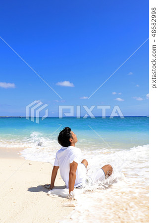 A man relaxing on a beautiful beach in the southern country A man relaxing on a beautiful beach in the southern country 48682998