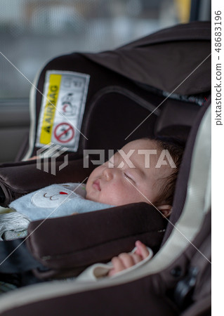 Baby sleeping on a child seat Baby sleeping on a child seat 48683196