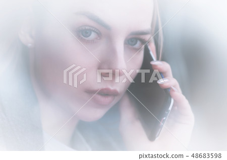 Closeup portrait attractive young girl talking on the phone look at camera. Non-contrast view Closeup portrait attractive young girl talking on the phone look at camera. Non-contrast view 48683598