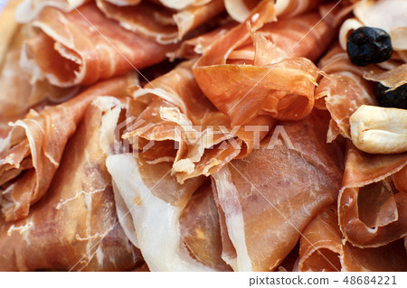 Closeup sliced fresh rolls of jamon. Summer Closeup sliced fresh rolls of jamon. Summer 48684221