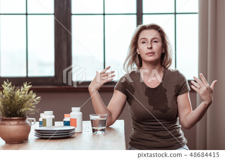 Woman having panic attack after taking too many pills Woman having panic attack after taking too many pills 48684415