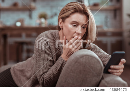 Woman feeling emotional after seeing message from husband Woman feeling emotional after seeing message from husband 48684473
