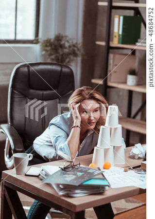 Blonde-haired woman feeling at a loss after problems at work Blonde-haired woman feeling at a loss after problems at work 48684752