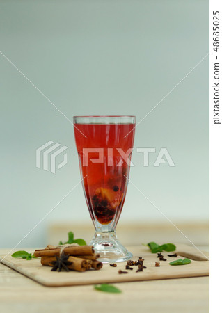 Cup of red hot vitamin tea on wooden table. winter 48685025