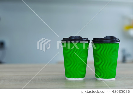 hot coffee in green takeaway paper cup. Coffee hot coffee in green takeaway paper cup. Coffee 48685026