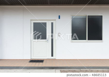sidewalk by street wall & door sidewalk by street wall & door 48685113