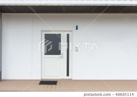 sidewalk by street wall & door sidewalk by street wall & door 48685114