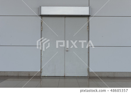 sidewalk by street wall & door sidewalk by street wall & door 48685357
