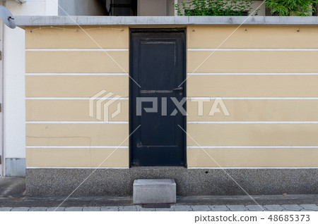 sidewalk by street wall & door sidewalk by street wall & door 48685373