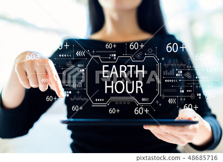 Earth hour with woman using tablet 48685716