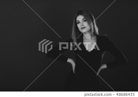 blonde woman posing in green dress on green background blonde woman posing in green dress on green background 48686435