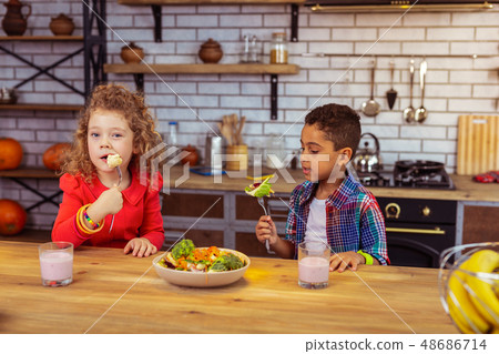 Cute blonde little female biting boiled cauliflower 48686714