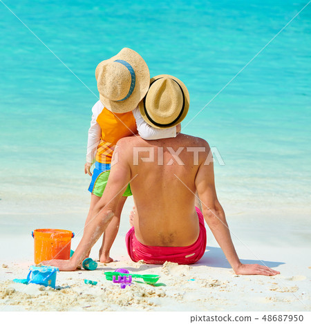 Toddler boy on beach with father 48687950