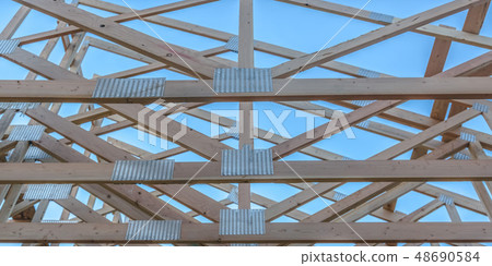 The horizontal beams of a wooden building pano 48690584