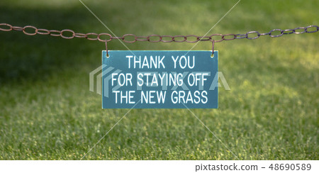 Thank you sign on a chain over a grassy lawn Thank you sign on a chain over a grassy lawn 48690589