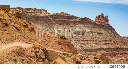 Sloping off road trail on an imposing mountain 48691006