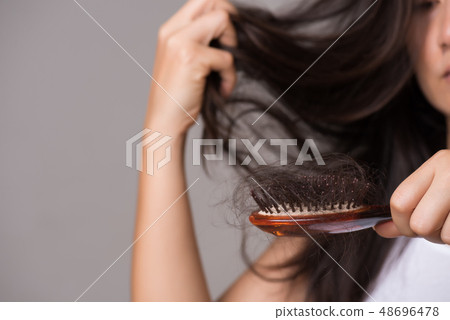 Woman show her brush with long lost hair 48696478