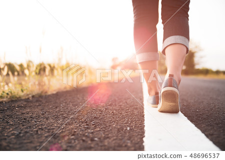 Closeup woman walking towards on the road side 48696537