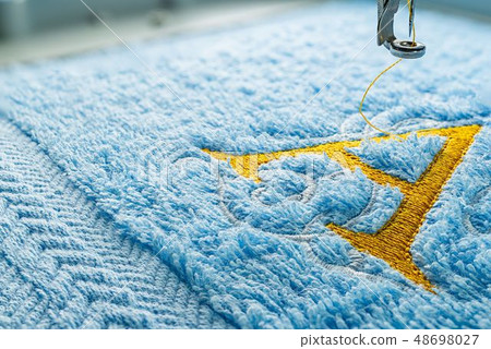 Embroidery machine and alphabet design on towel Embroidery machine and alphabet design on towel 48698027