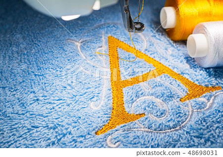 Embroidery machine and logo design on towel Embroidery machine and logo design on towel 48698031