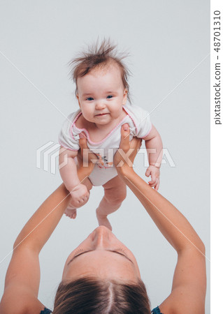 baby in the arms of the mother. Woman holding a baby in the arms of the mother. Woman holding a 48701310