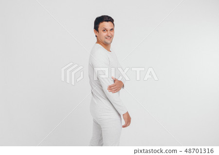 beautiful smiling man in a white tracksuit on a 48701316