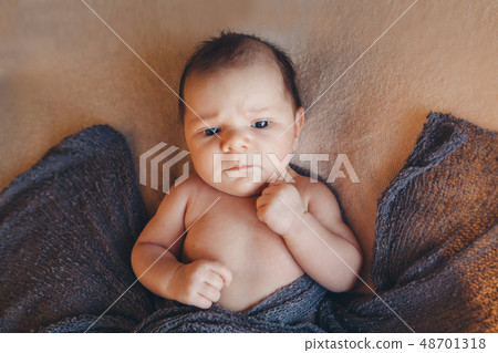 boy with his mouth open is lying on a white boy with his mouth open is lying on a white 48701318