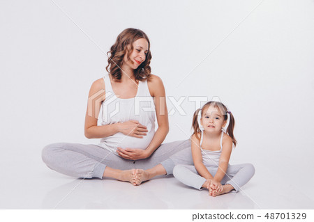 international women day: pregnant woman and little 48701329