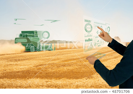 Farmer controls autonomous harvester. Farmer controls autonomous harvester. 48701706