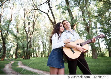 young couple walking in the forest and playing 48704482