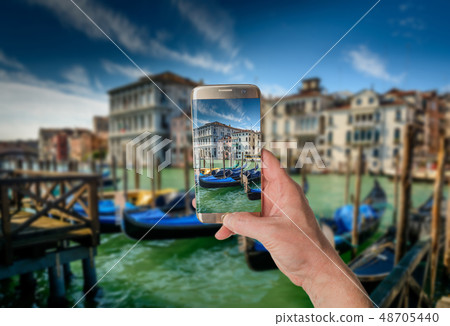 Man taking photo of Gondolas in Venice Man taking photo of Gondolas in Venice 48705440