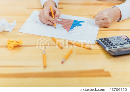 Work in the office. Reporting business growth statistics. Broken yellow crayons calculator lie on 48706550