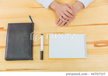Black notebook with black marker on the table top view.. At the office desk is a black notebook. Black notebook with black marker on the table top view.. At the office desk is a black notebook. 48707337