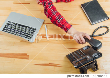 Close-up of women's hands in an office with a phone in their hands lying on the table, workplace 48708455
