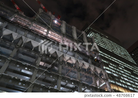 Office building at night and office building under construction Office building at night and office building under construction 48708617