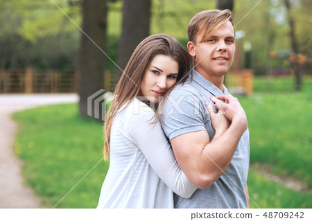 Happy couple expecting pregnancy portrait in park Happy couple expecting pregnancy portrait in park 48709242