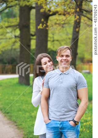 Happy couple expecting pregnancy portrait in park Happy couple expecting pregnancy portrait in park 48709243