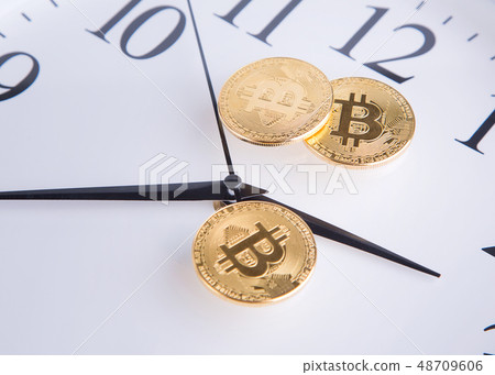 Gold coins and clock hands. Gold coins and clock hands. 48709606