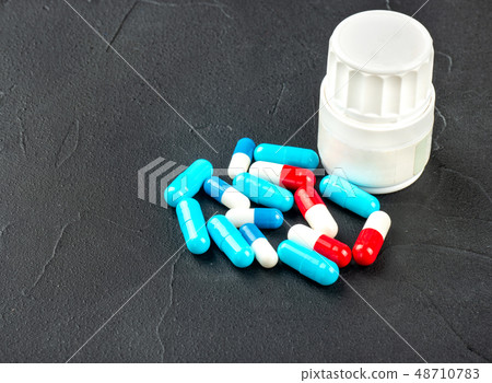 Scattered multicolored capsules Scattered multicolored capsules 48710783