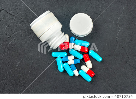 Scattered multicolored capsules 48710784