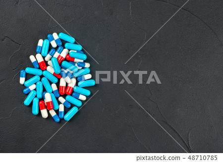 Scattered multicolored capsules 48710785