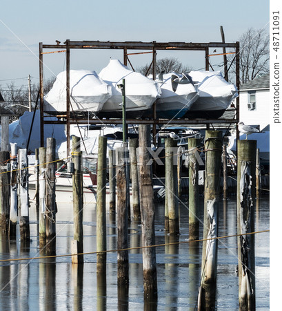 Boats shrink wrapped for the winter stored over 48711091