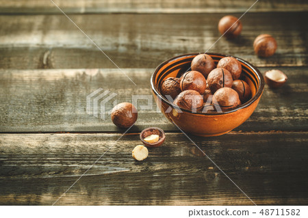 Macadamia nuts on wooden table 48711582