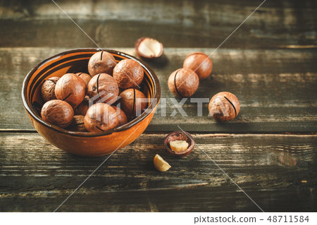 Macadamia nuts on wooden table 48711584